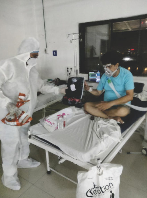 Volunteer in PPE at a hospital ward