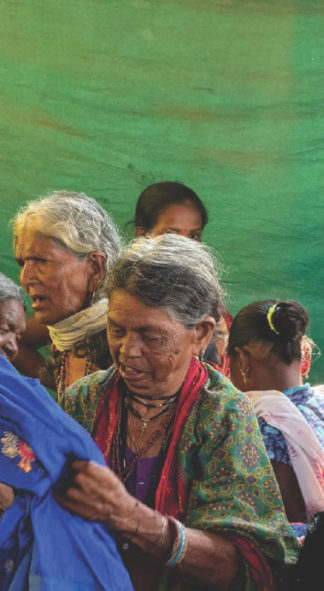 An elderly woman receiving clothes